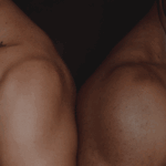 Close-up of two muscular male shoulders, symbolising strength and results from peptide therapy.