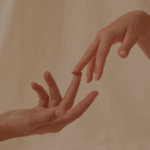 Two hands reaching toward each other, symbolising connection, hormone therapy, and fertility support.